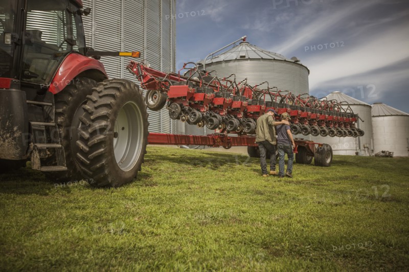 Caucasian farmer and son walking on farm