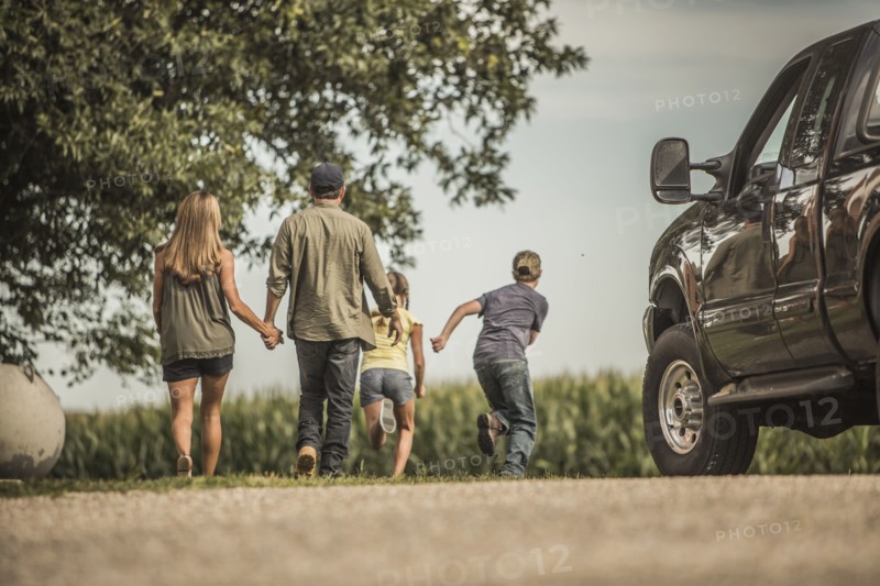 Caucasian family walking on farm