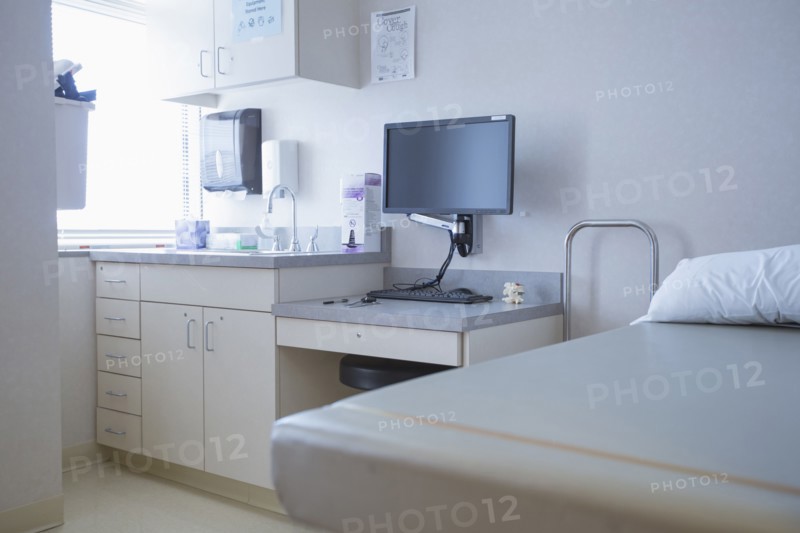 Empty bed and television in hospital room