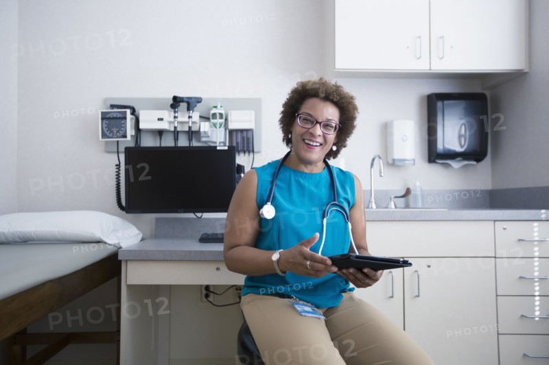 African American doctor holding digital tablet