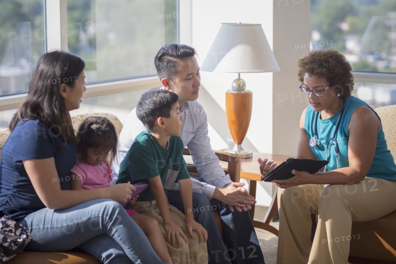 Doctor and patients using digital tablet