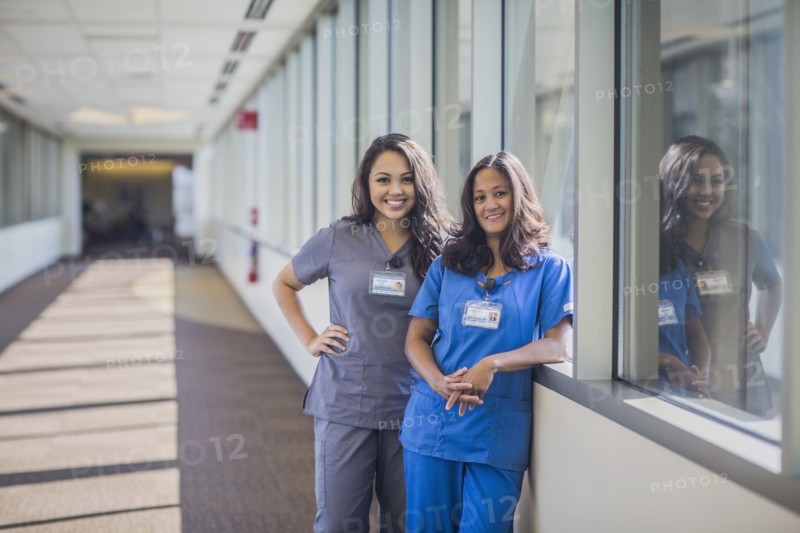 Nurses smiling in hospital hallway