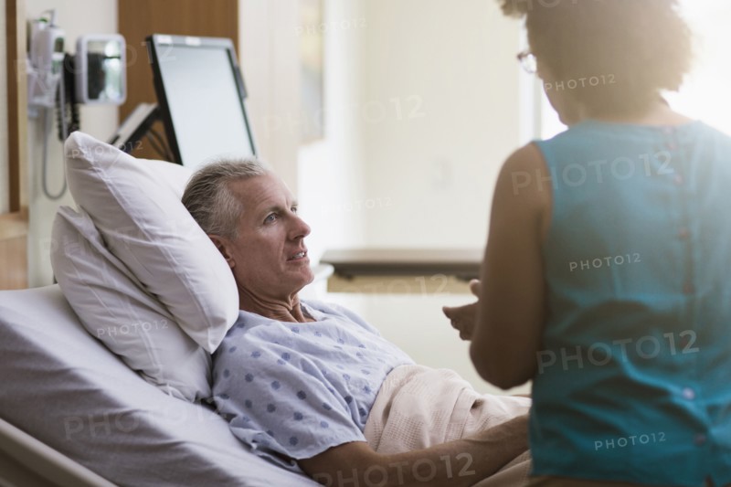 Doctor talking to patient in hotel room