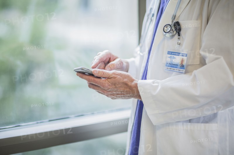 Caucasian doctor using cell phone