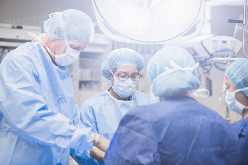 Surgeons working in operating room