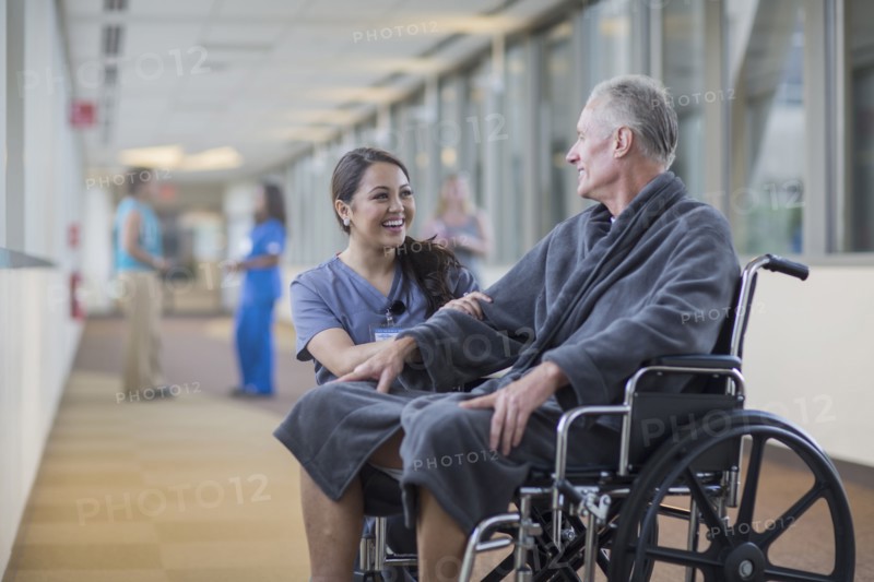 Nurse talking to patient in wheelchair