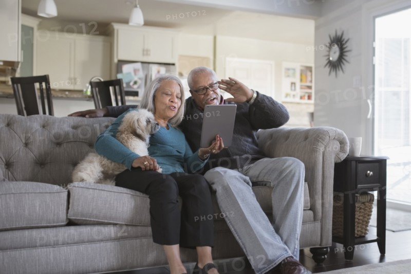 Older couple video chatting with digital tablet