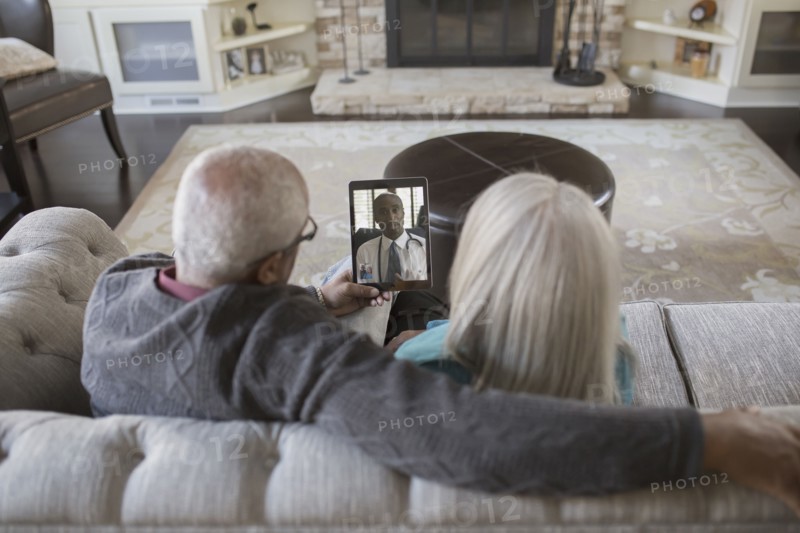Older couple video chatting with digital tablet