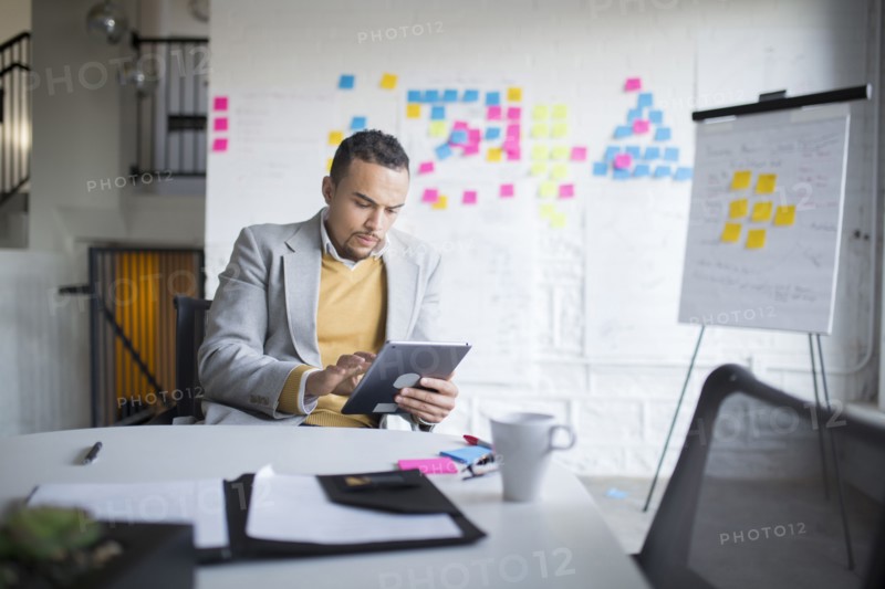 Businessman using digital tablet in office