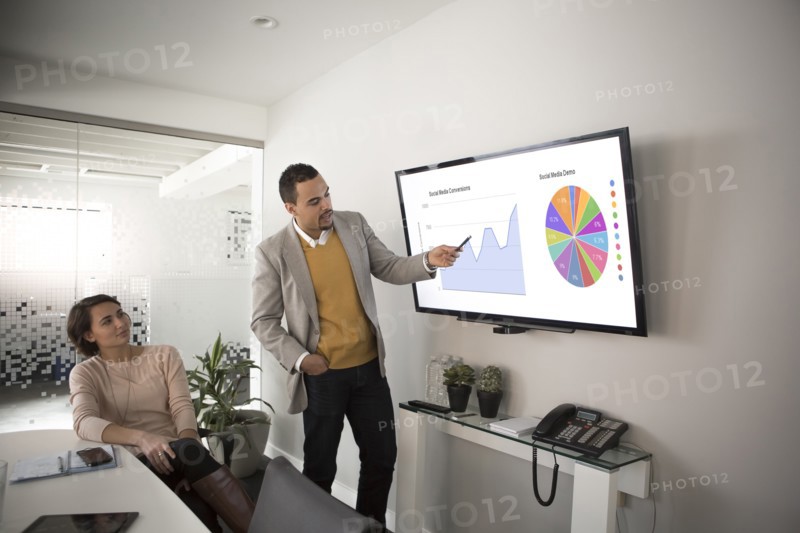 Businessman pointing to charts in meeting