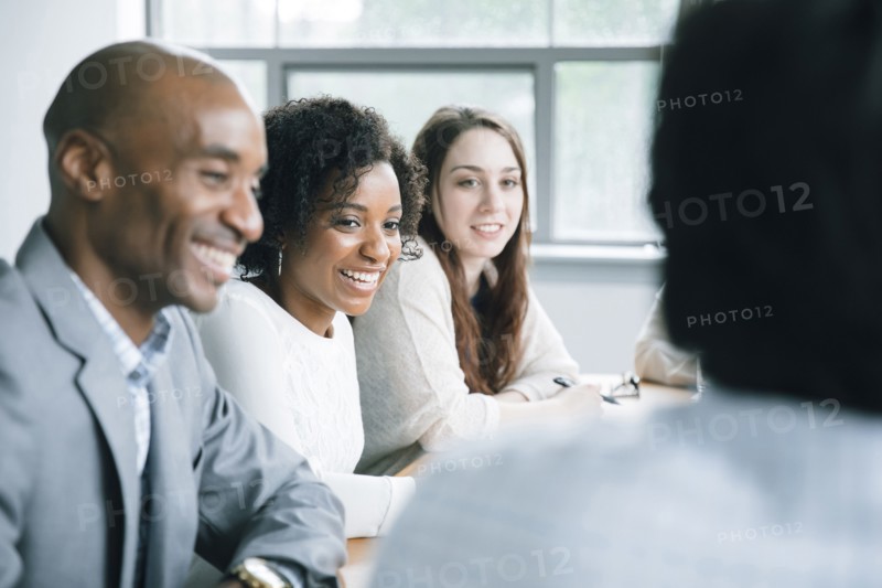 Business people laughing in meeting