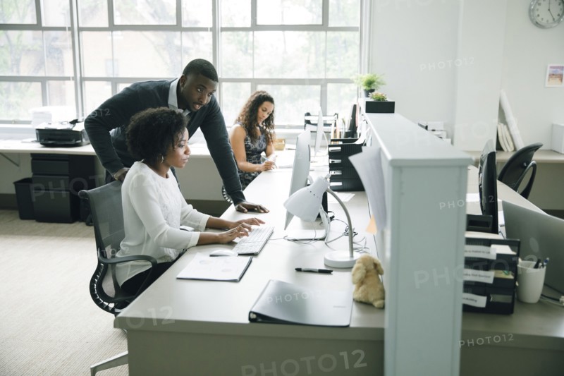 Business people using computer in office