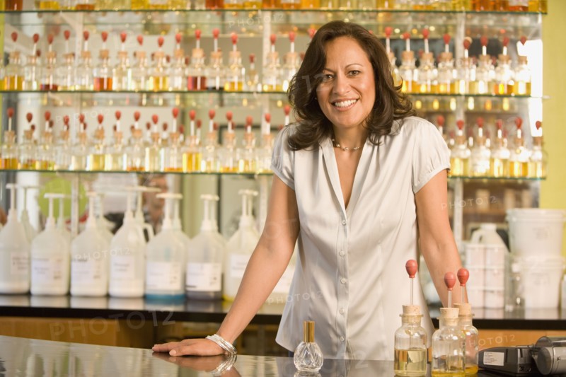 Hispanic female sales clerk at perfume store