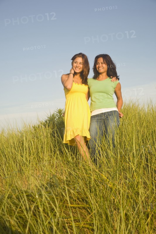 Asian mother and daughter in dune grass