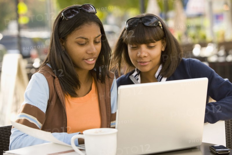 African teenaged girls looking at laptop