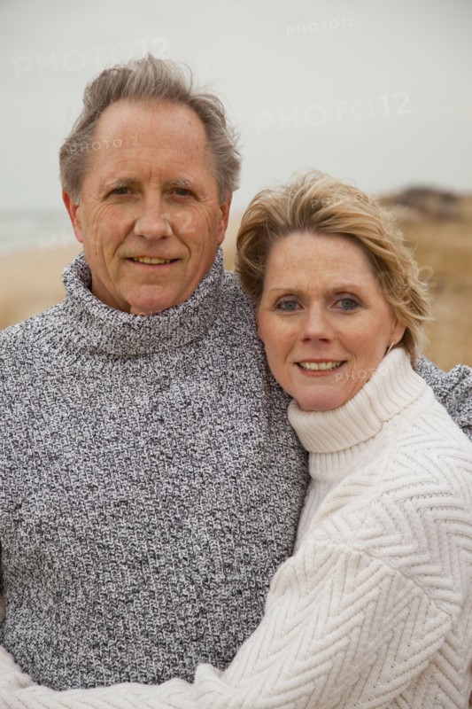 Caucasian couple hugging on beach