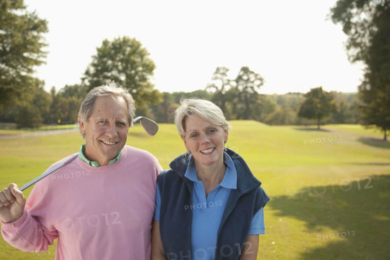 Couple standing on golf course