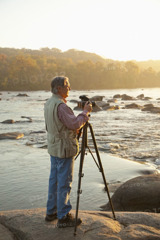 Man taking photographs on beach