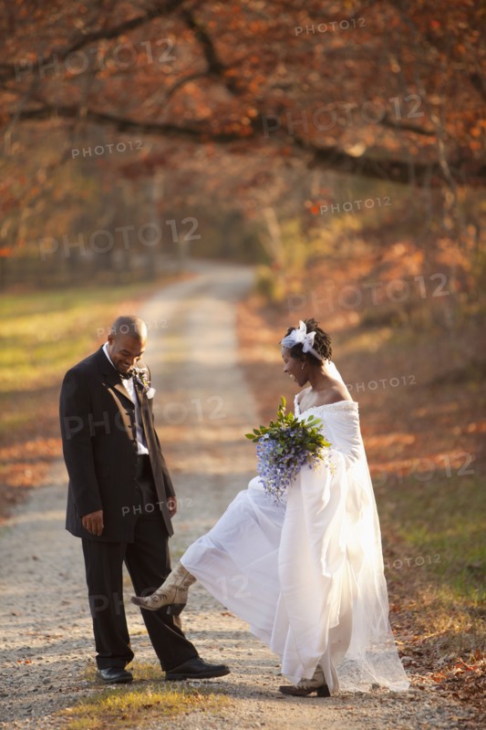 Bride and groom standing on path