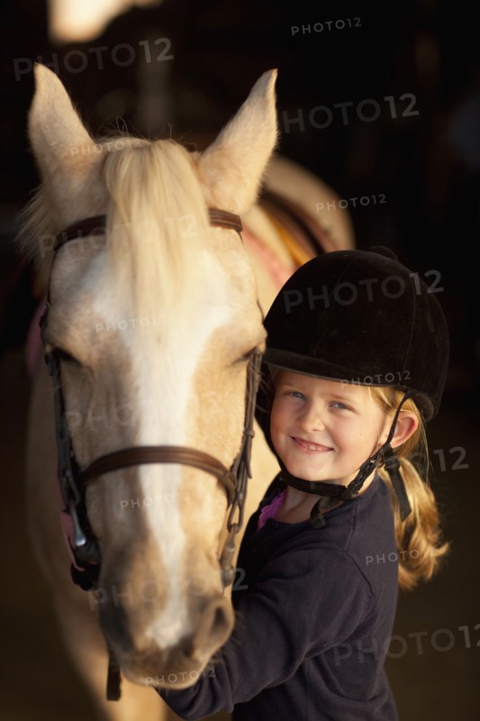 Caucasian girl standing with horse