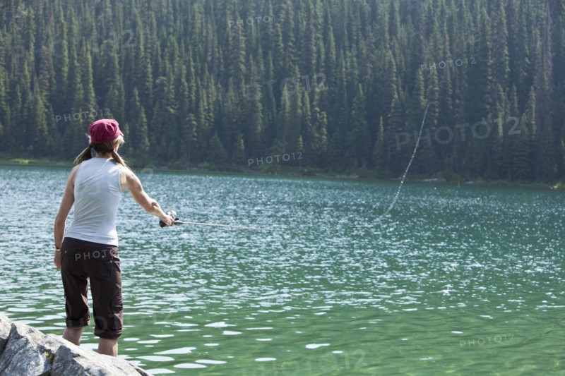 Caucasian woman fishing in lake