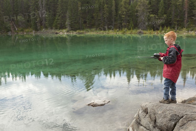 Caucasian boy fishing in the Valley of the Five Lakes