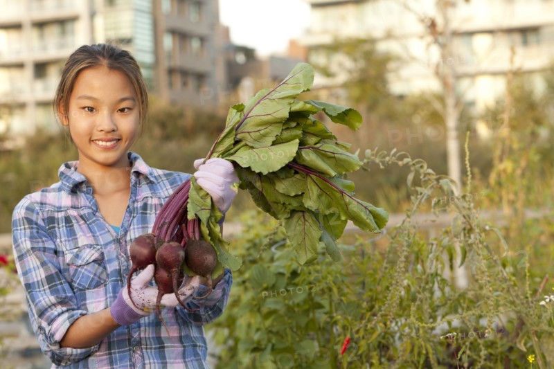 Japanese girl holding bunch of beets