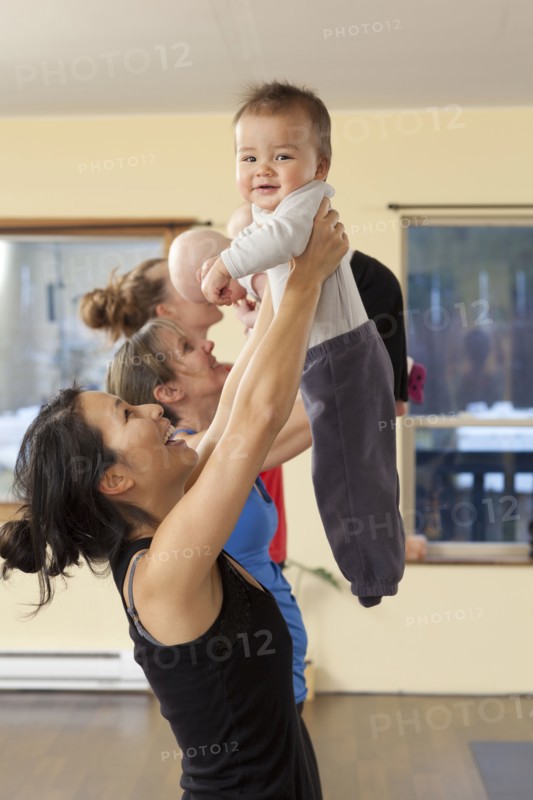 Mothers and babies taking yoga class