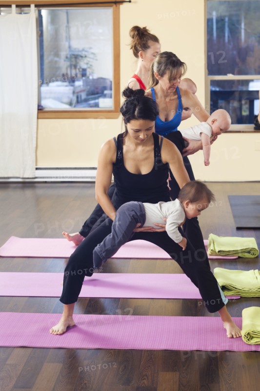 Mothers and babies taking yoga class