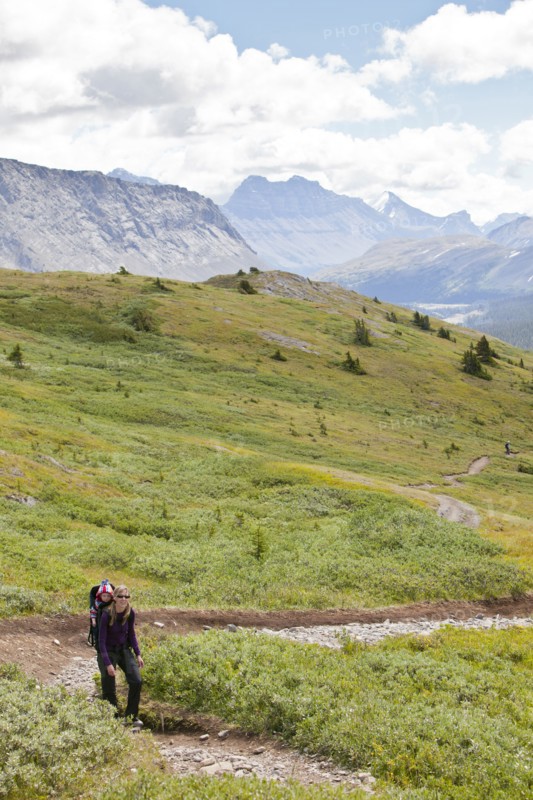 Caucasian mother and baby on path in mountain landscape