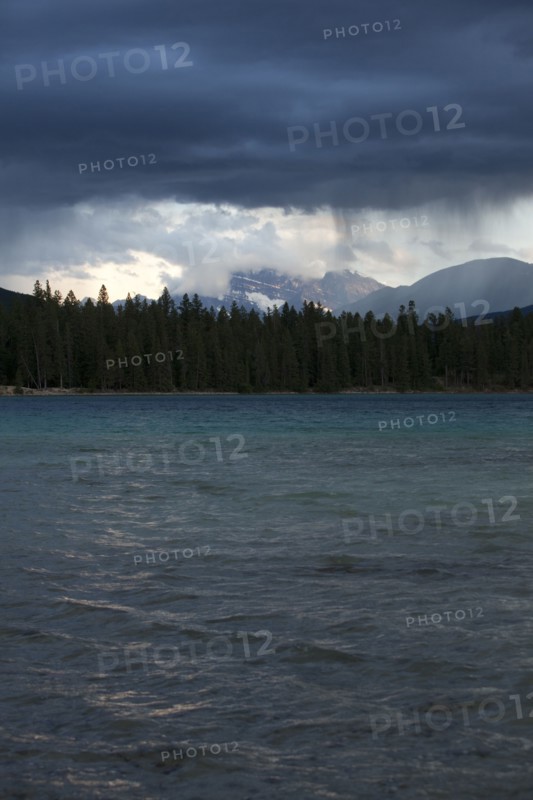Storm clouds raining over lake