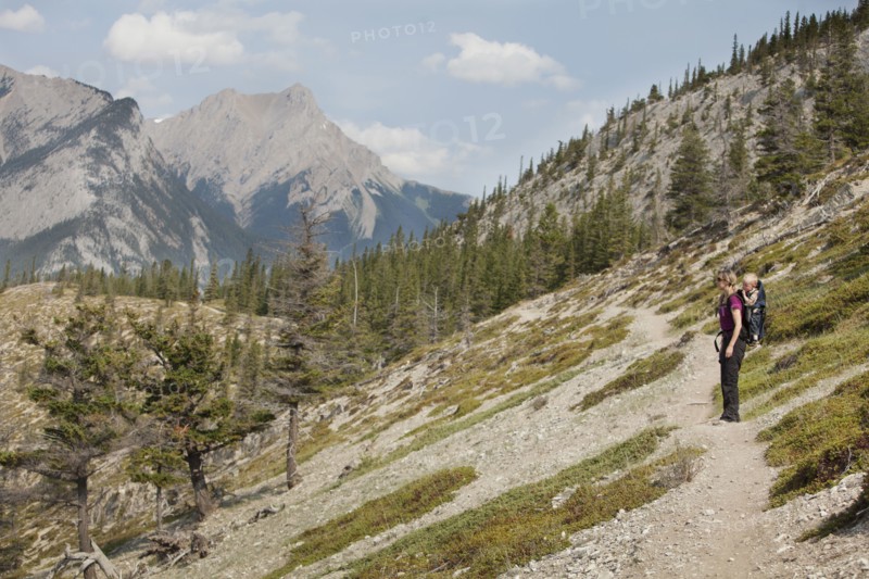 Caucasian mother and son hiking on remote hillside