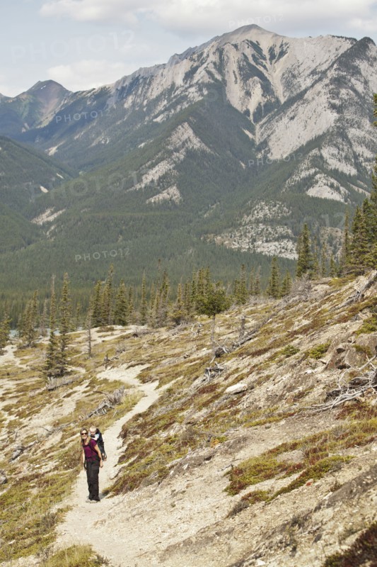 Caucasian mother and son hiking on remote hillside