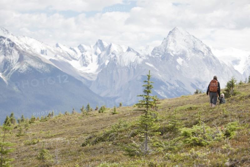 Caucasian mother and son hiking on remote hillside