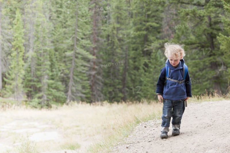 Caucasian boy hiking in forest
