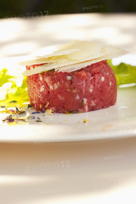 Parmesan cheese atop steak tartare