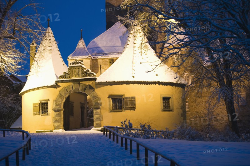 Snow covered village building at night