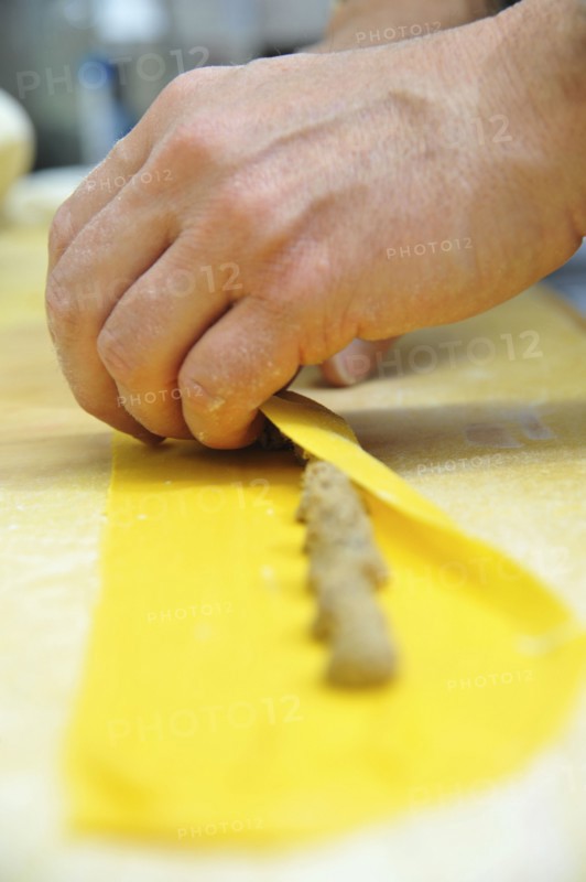 Chef rolling homemade agnolotti pasta
