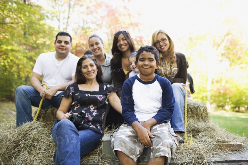 Adults and children sitting on hay ride