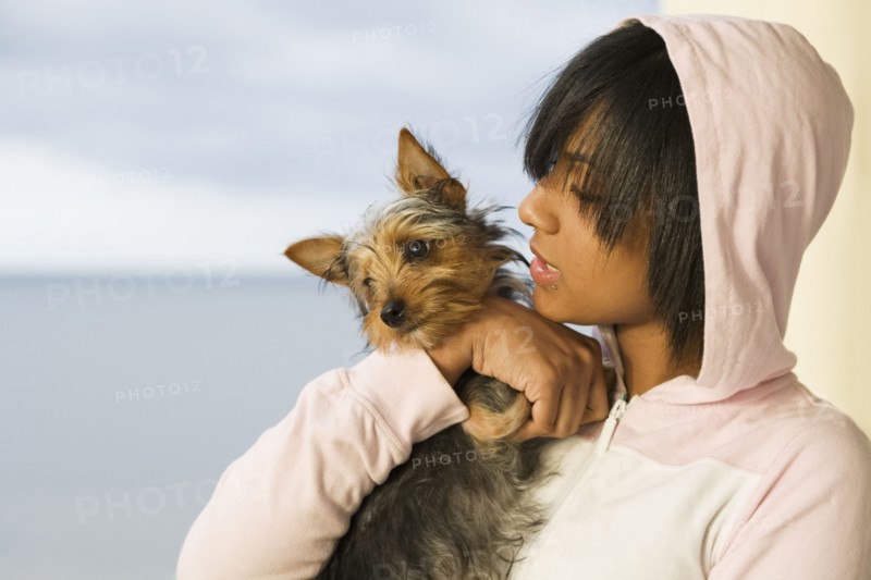 Hispanic teenage girl holding dog