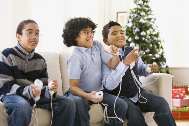 Boys playing video game at Christmas