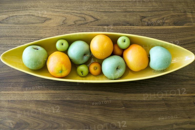 Bowl with fruit on wooden table