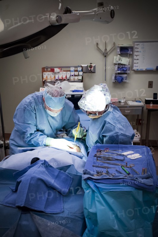 Surgeons operating on patient in hospital