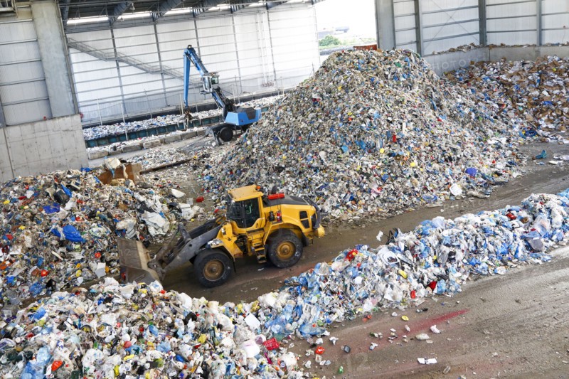 Bulldozer pushing pile of trash