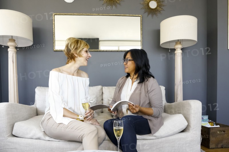 Women with champagne reading book