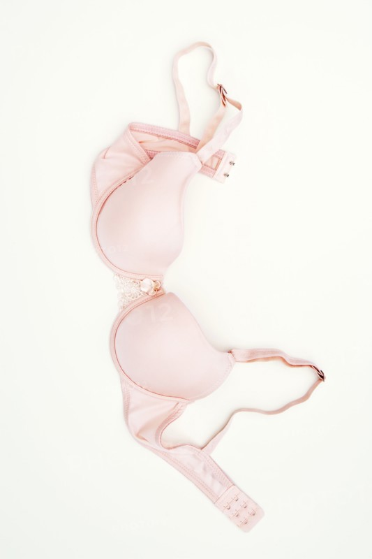 Pink bra laying on ground