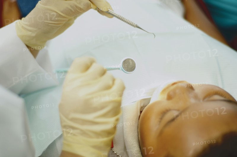 High angle view of dentist working on African boy