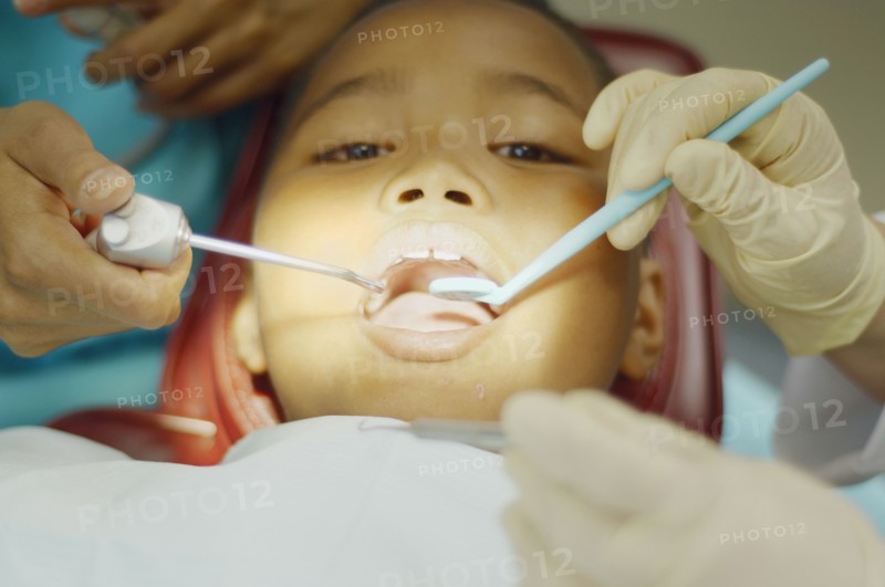 Dentist working on young African boy
