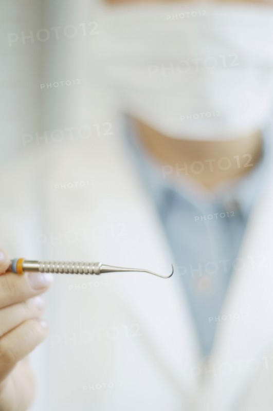 Close up of dental tool in dentist's hand