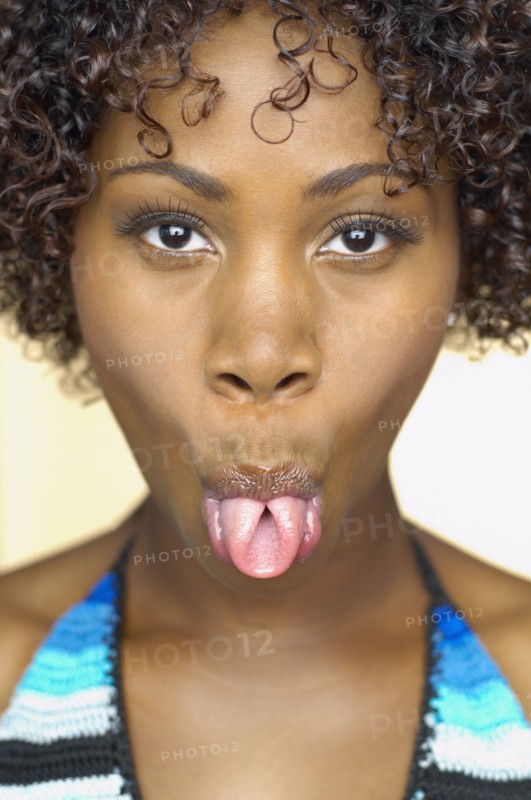 Close up of African woman sticking out tongue